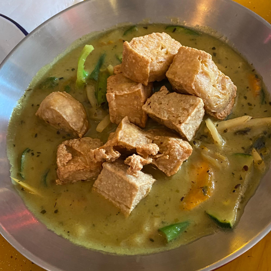 a large dish of tofu green thai curry