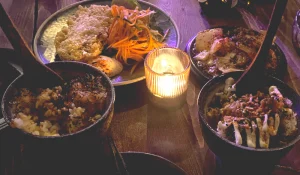candle lit table with various small plates